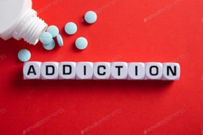 The words "addiction" spelled out in blocks with pills spread around them, highlighting the importance of National Substance Abuse Awareness Month